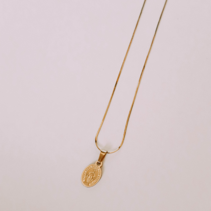 Miraculous Medal charm on a gold slink chain